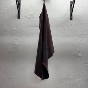 Stretch lamb leather in rich burgundy color – distressed texture with high gloss for sleek apparel